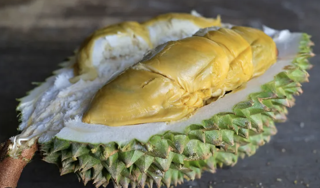 Durian Tupai King dibelah menunjukkan daging kuning keemasan dengan semburat hijau